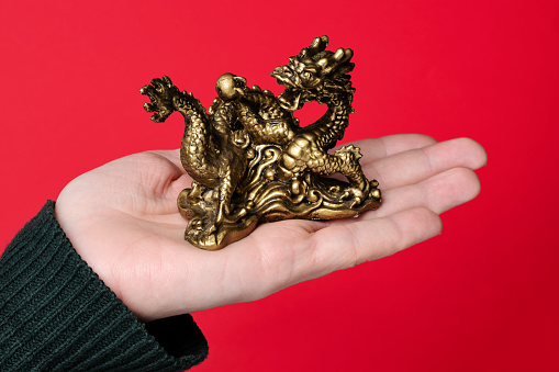 Chinese New Year. Dragon on a red background. Golden dragon. Chinese symbol. Bright red background