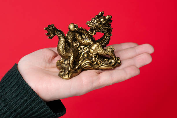 Chinese dragon on the hand on a red background stock photo