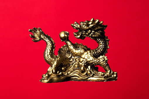 Golden dragon on red background. New Year's Eve on the Chinese calendar