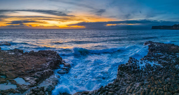 istock Sunrise over the sea and rock platform with high cloud 1979645660