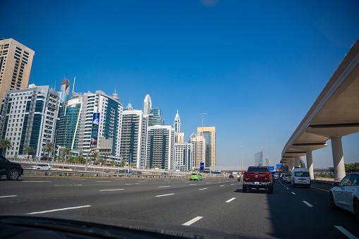 Dubai, UAE - December 1, 2023: View of the roadside from car windshield to Dubai city, United Arab Emirates. High quality photo