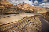 Greater Himalayas, dried river bed and the highway, en route Leh, Ladakh