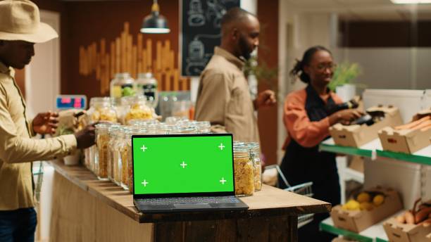 istock Laptop running isolated greenscreen on display in grocery store 1979678153