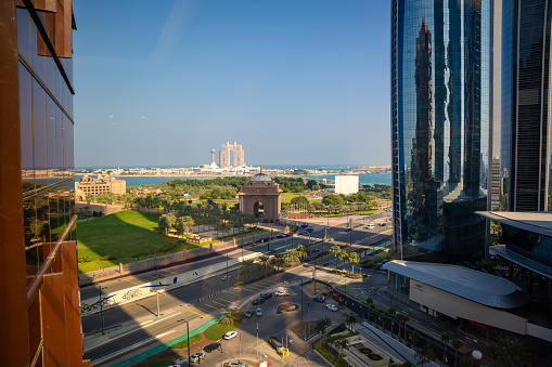 Abu Dhabi, United Arab Emirates - December 4, 2023: View from building of gate to the Emirates Palace hotel and Rixos hotel on background in Abu Dhabi, UAE. High quality photo
