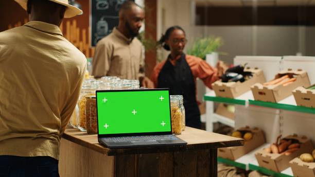 istock Laptop on stall at supermarket showing greenscreen template 1979684424