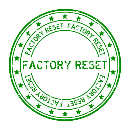 Grunge green factory reset word with star icon round rubber seal stamp on white background