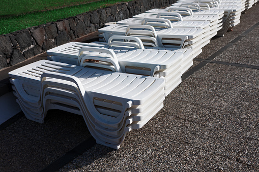 Row of white sun loungers on the ground in the aqua park