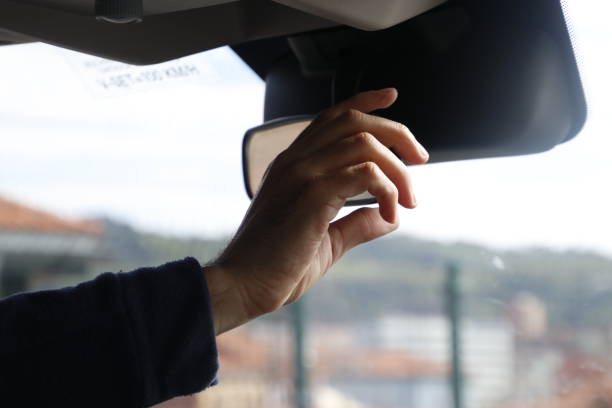 istock a man driving his car with both hands on the side mirror 1979708279