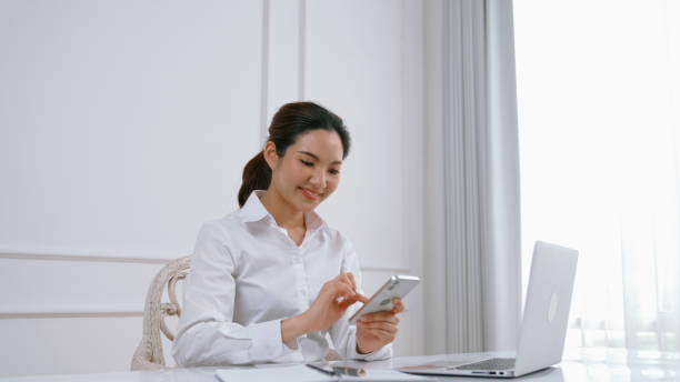 istock Young woman using smartphone browsing for online shopping E commerce by online payment gateway at vivancy home. Modern and convenience online purchasing make secure and convenient purchases. 1979724409