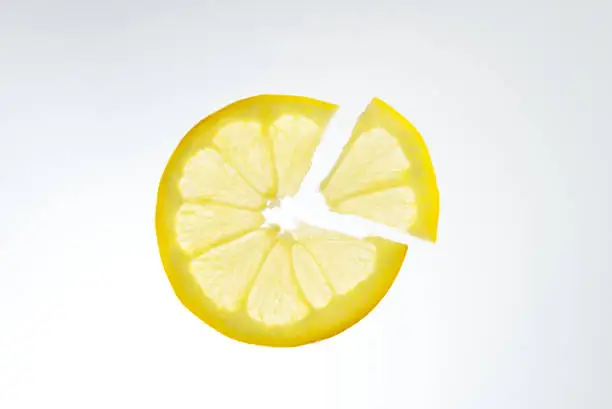 Fruit lemon sliced into slices on white background.