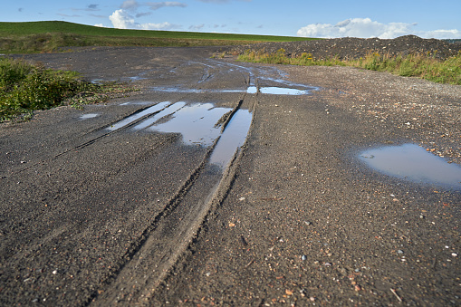 Puddle and dirt on the road.