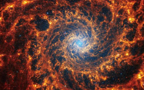 Face-on spiral galaxy, NGC 628. Bright orange and red galactic long-range captured imagery. Elements of this image furnished by NASA (observed by the Webb telescope) Face-on spiral galaxy, NGC 628. Bright orange and red galactic long-range captured imagery. Elements of this image furnished by NASA (observed by the Webb telescope) spiral galaxy stock pictures, royalty-free photos & images