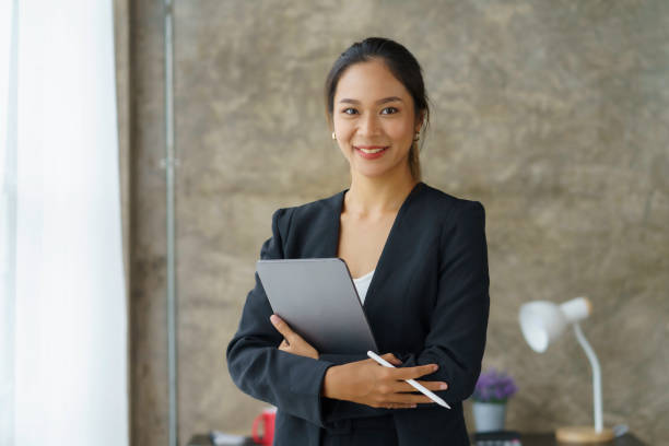 istock Beautiful Asian businesswoman standing confidently preparing for work. 1979786016