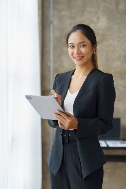 istock Beautiful Asian businesswoman standing confidently preparing for work. 1979786421