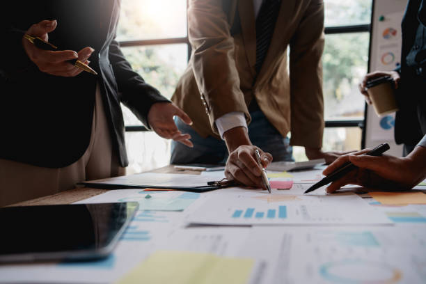 istock Group of businesspeople meeting and presenting, discussing and analyzing data, pointing to charts and graphs of finance and accounting, business ideas for future growth. 1979807469