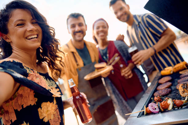 istock Happy friends taking selfie while gathering for barbecue party in the backyard. 1979817527