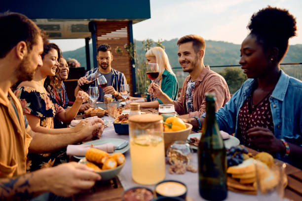 istock Happy man raising a toast while having lunch with friends on a patio. 1979818731