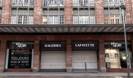 Strasbourg, France - Nov 3, 2020: Closed entrance and showcases of Galleries lafayette building department store the iconic building during the second wave of COVID-19 coronavirus lockdowns