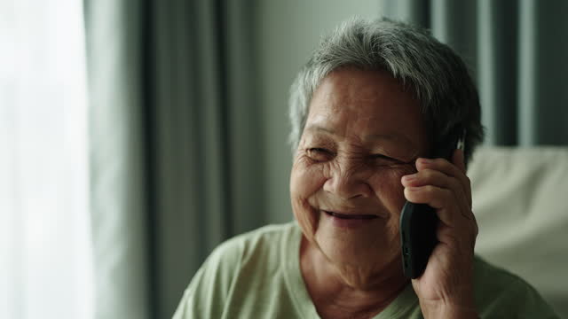 Elderly talking phone.