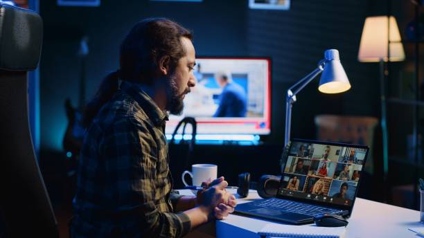 istock Remote worker greeting colleagues during videocall in apartment office 1979878477