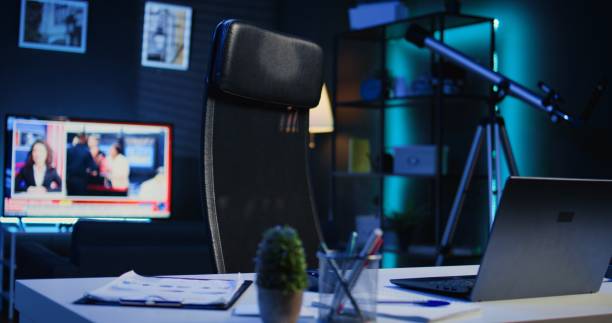 istock Laptop, mini house plants and headphones on table in empty room 1979884892