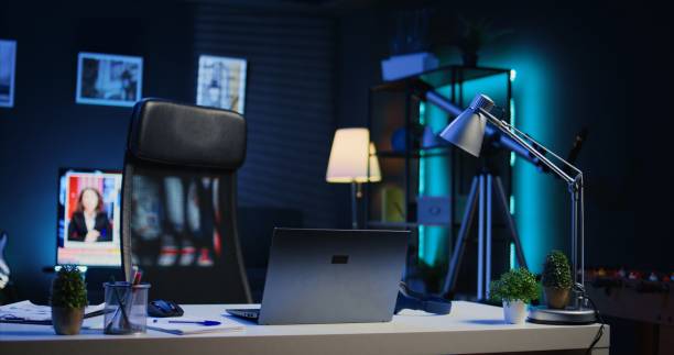 istock Smart TV left open on news broadcast in empty home office with desk 1979888128
