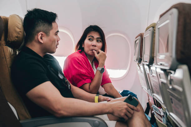 istock young couple in flight exited to go on vacation 1979890733