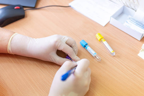 istock Scientist writing on test tubes in a laboratory clinic on blurred background. 1979891285