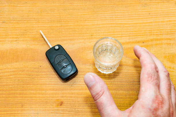 drunk driving - the cause of car accidents. hand reaches for car key and alcohol.drink. male hands and auto keys. - drunk driving alcohol key law 뉴스 사진 이미지