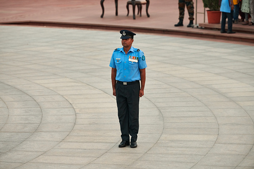 New Delhi, India - 23.10.2022 - Indian honor guard officer stands at attention in Amar Jawan Jyoti at Amar Chakra in National War Memorial symbolizing a solemn tribute to fallen heroes