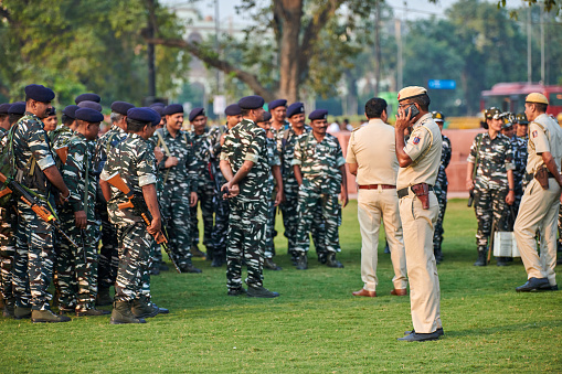 New Delhi, India - 23.10.2022 - Indian police and military detachment await orders from higher authorities as military units stand on green lawn in city downtown, military parade preparation