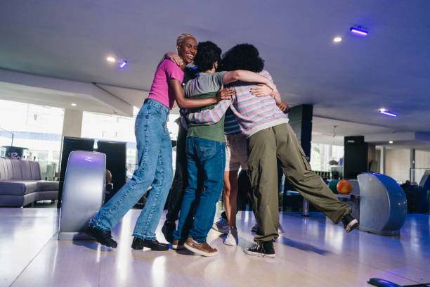 istock Friends embracing while celebrating at a bowling club 1979946148