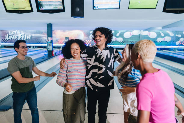 istock Friends embracing while celebrating at a bowling club 1979946660