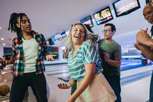 Friends having fun while bowling and speding time together