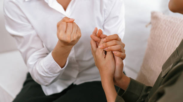 istock Supportive and comforting hands cheering up depressed patient person or stressed mind with empathy. Psychologist reassuring stressful and sad patient in vivancy clinic. 1979951979