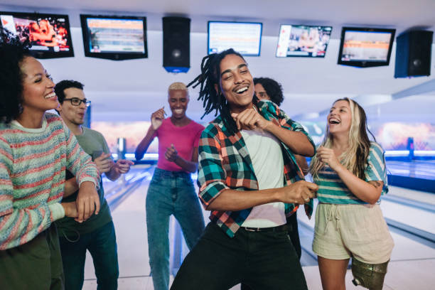 istock Young man dancing with friends at a bowling club 1979952486