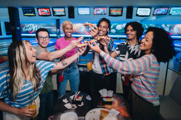 istock Friends toasting with pizza at a bowling club 1979956168
