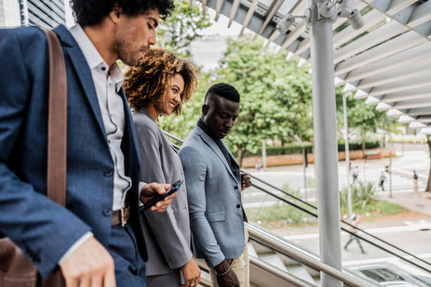 istock Coworkers talking while moving down the stairs outdoors 1979963866