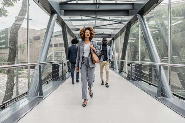 istock Businesswoman walking on a footbridge 1979965493
