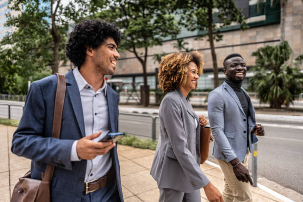 istock Coworkers talking while walking in the street 1979966575