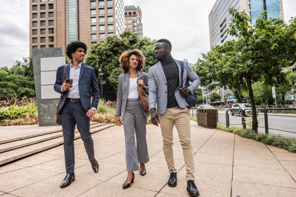istock Coworkers talking while walking in the street 1979966586