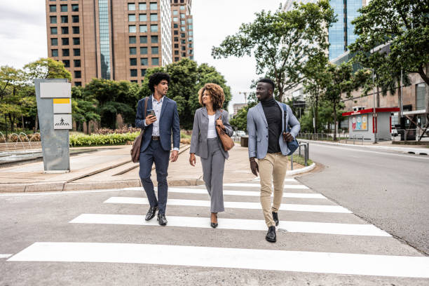 istock Coworkers talking while walking in the street 1979966596