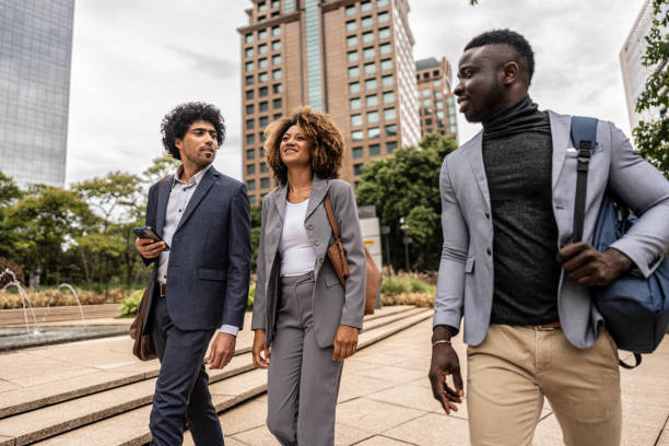 istock Coworkers talking while walking in the street 1979966599