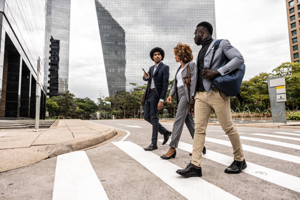 istock Coworkers talking while walking in the street 1979967105