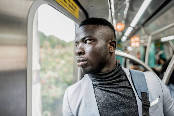 istock Businessman looking through window on the train 1979968227