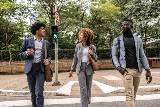 istock Coworkers talking while walking in the street 1979968233