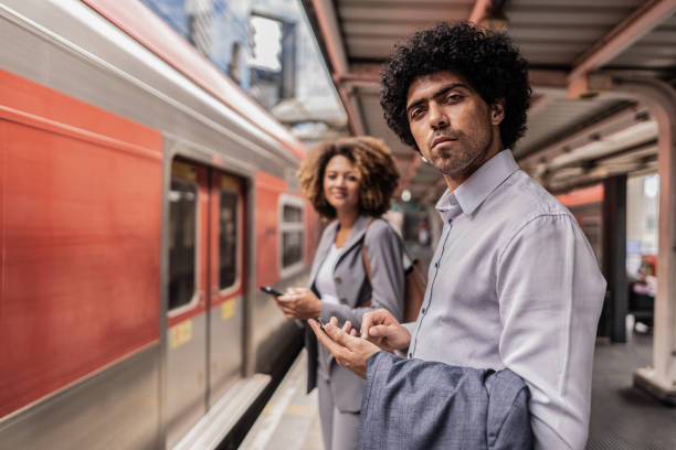 istock Portrait of a businessman using the mobile phone while waiting for the train on the platform 1979970926