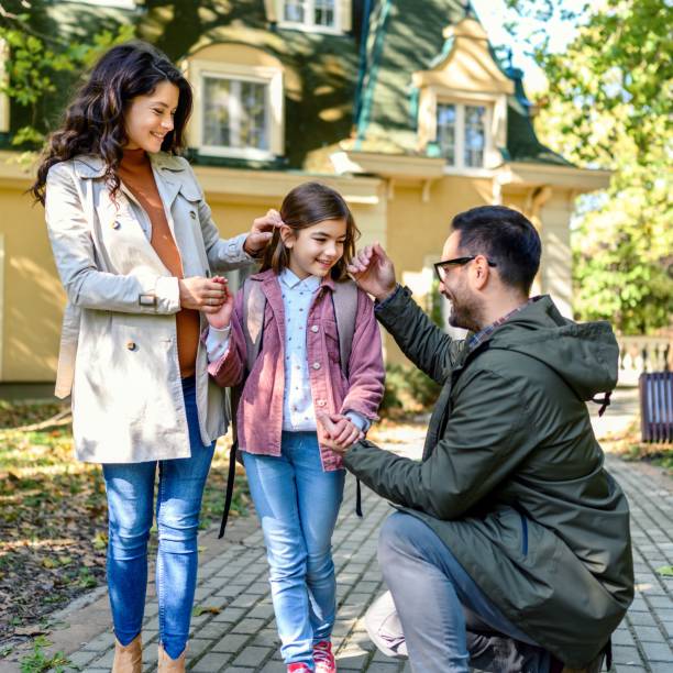 istock Mother and father taking their daughter to school 1979984695