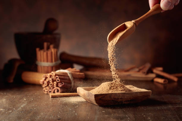 istock Cinnamon powder is poured into a wooden bowl. 1979991093