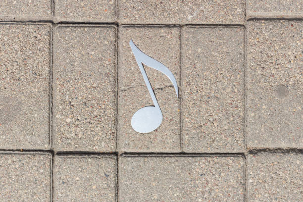 istock City pavement metal music note decor, outdoors background.Top view. Copy space. 1979993828
